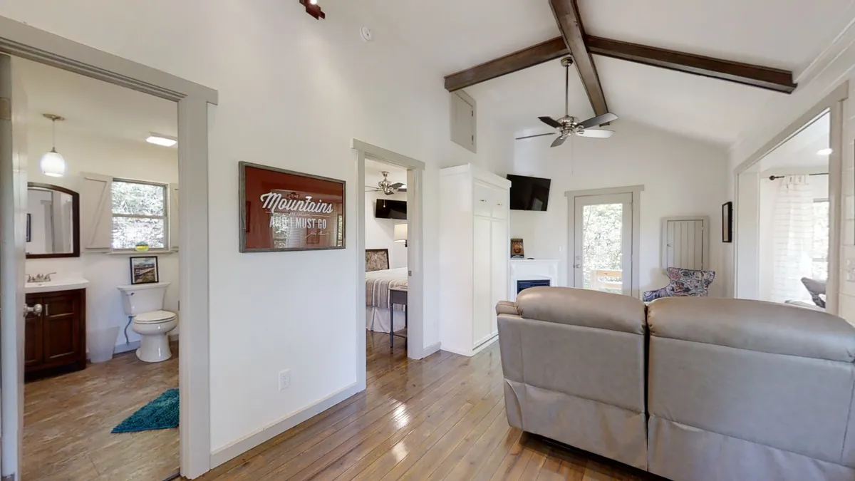 This image shows a comfortable seating area with inviting decor, soft lighting, and an open doorway that hints at easy movement between indoor and outdoor spaces. The décor and natural light evoke a welcoming, homey ambiance that encourages relaxation after outdoor adventures.